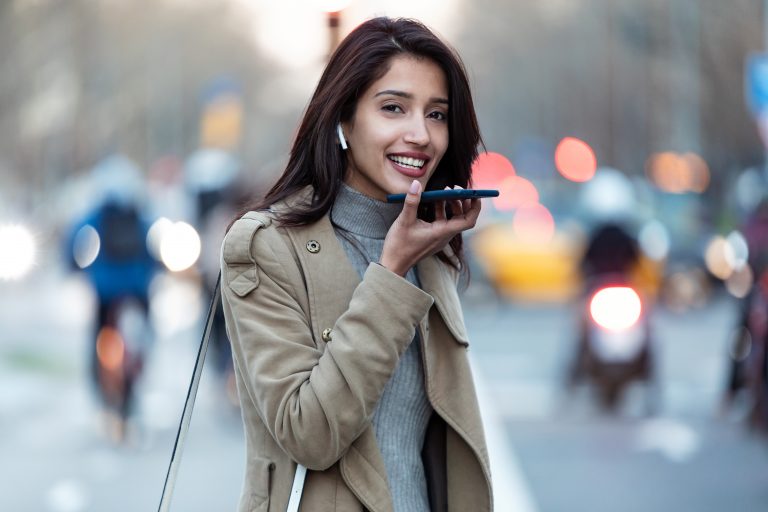 young woman using virtual assistant from her smart phone