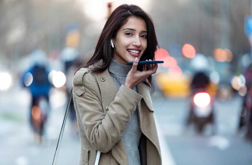 young woman using virtual assistant from her smart phone